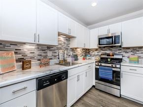 Manchester apartment for rent - a kitchen with stainless steel appliances and white cabinets