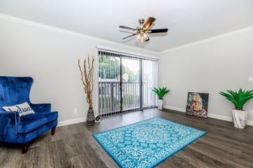 Manchester apartment for rent - a living room with a blue chair and a ceiling fan