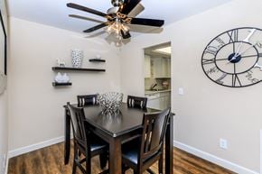Manchester apartment for rent - a dining room with a table and chairs and a large clock on the wall