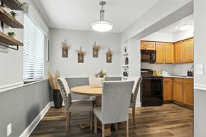 St. Louis apartment for rent - A kitchen with a table and chairs in the middle of the room.