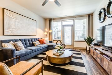 Aurora apartment for rent - A living room with a blue couch and a coffee table.