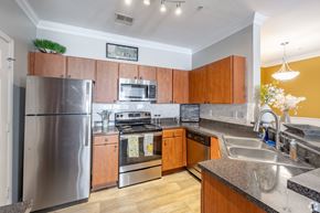 Goodlettsville apartment for rent - A kitchen with wooden cabinets and stainless steel appliances.