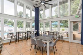 St. Louis apartment for rent - A dining room with a table and chairs and a ceiling fan.
