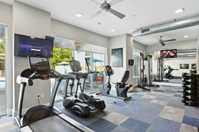 Weldon Springs apartment for rent - A gym with a treadmill, weights, and exercise equipment.