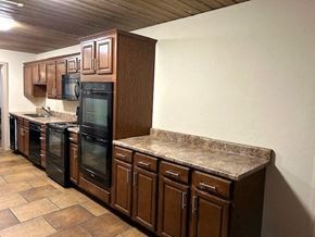 St. Louis apartment for rent - a kitchen with granite counter tops and a refrigerator