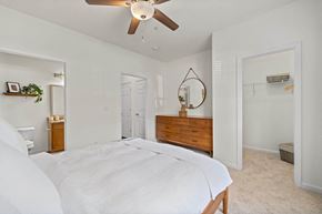Canton apartment for rent - A bedroom with a large bed and a ceiling fan.