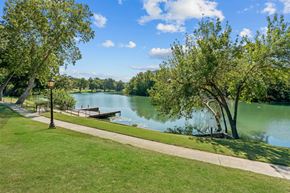 New Braunfels apartment for rent - A serene park with a lake, trees, and a clear sky.