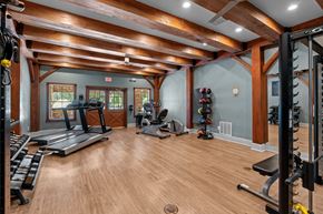 New Braunfels apartment for rent - A spacious home gym with wooden floors and a variety of exercise equipment.