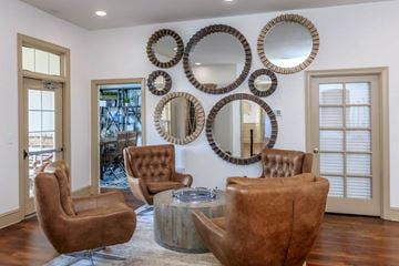 Goodlettsville apartment for rent - a living room with leather chairs and mirrors on the wall