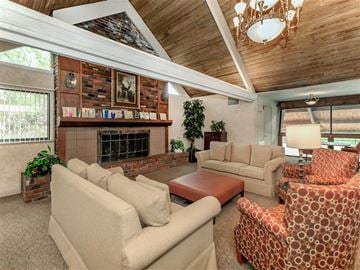 St. Louis apartment for rent - a living room with couches and chairs and a fireplace