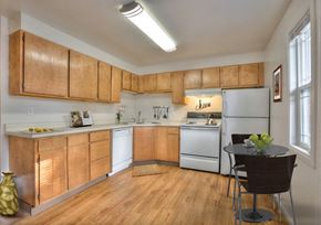Fort Collins apartment for rent - Village on Leisure interior kitchen with white and wood cabinetry