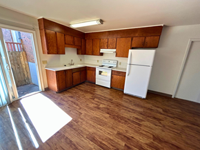 Fort Collins apartment for rent - A kitchen with wooden floors and white appliances.