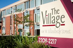 Fort Collins apartment for rent - A sign for The Village on W. Elizabeth Street with a phone number.