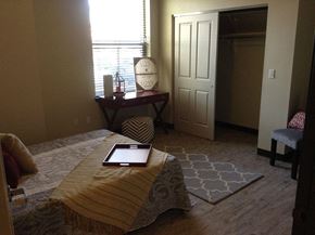 Fort Collins apartment for rent - a bedroom with a bed and a tablet on top of it