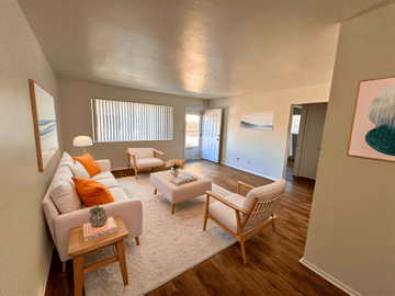 Fort Collins apartment for rent - A living room with a white couch, a wooden coffee table, and a painting on the wall.