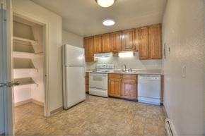 Fort Collins apartment for rent - A kitchen with white appliances and wooden cabinets.