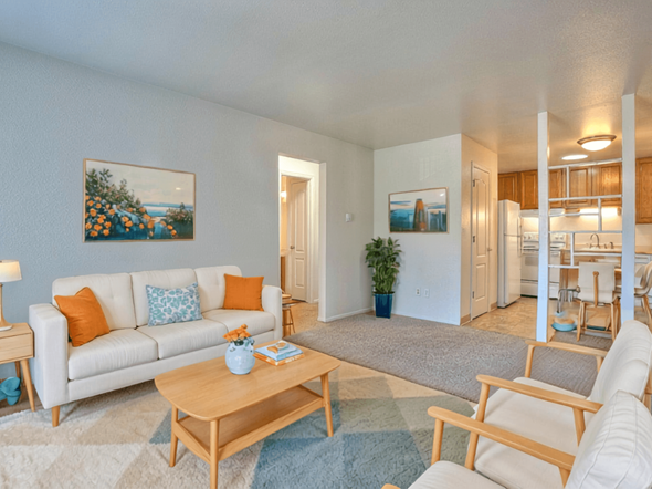 Fort Collins apartment for rent - A living room with a white couch, a coffee table, and a painting on the wall.