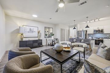 Grapevine apartment for rent - A modern living room with a grey sofa and a black coffee table.