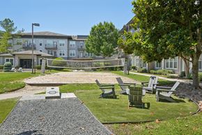 Cypress apartment for rent - Outdoor recreation area with volleyball court and seating at Highline Urban Lofts Apartments, Cypress, TX