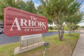 Cleburne apartment for rent - Property entrance monument sign with landscaping at Arbors Of Cleburne Apartments, Cleburne, TX
