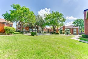 Arlington apartment for rent - A grassy area in front of a row of houses at Bardin Oaks Apartments, Arlington, Texas