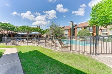 Arlington apartment for rent - A sunny day at the poolside with a building in the background.