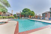 Bedford apartment for rent - A large swimming pool surrounded by a red brick border at Copper Hill Apartments, Bedford, TX