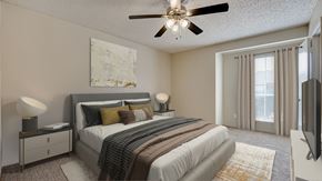Bedford apartment for rent - A bedroom with a large bed, a ceiling fan, and a painting on the wall at Copper Hill Apartments, Bedford 76021