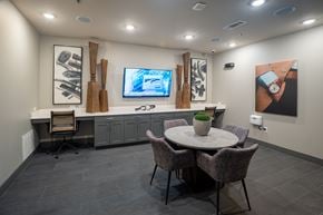 Grapevine apartment for rent - A modern dining room with a round table and grey chairs.