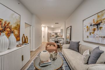 Dallas apartment for rent - A living room with a grey couch and a coffee table.