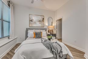 Dallas apartment for rent - Bedroom with upholstered bed and abstract artwork at The Montrose Apartments, Dallas, TX 75204