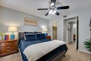 Fort Worth apartment for rent - nightstand, and a ceiling fan in bedroom at Southern Oaks, Texas, 76132