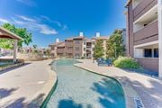 Dallas apartment for rent - A swimming pool in a residential area surrounded by buildings and trees. at Timberglen Apartments, Dallas