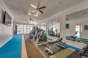 Dallas apartment for rent - Fitness center with cardio equipment and mirrors at Vue Live Oak Apartments, Texas, 75204