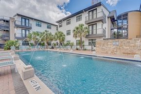 Dallas apartment for rent - Resort style pool with palm trees and lounge chairs at Vue Live Oak Apartments, Texas, 75204
