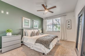 Dallas apartment for rent - A bedroom with a bed, dresser, and window.