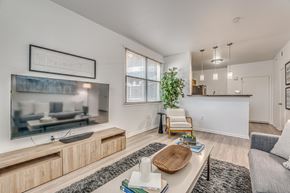 Dallas apartment for rent - A living room with a television, a chair, and a table.