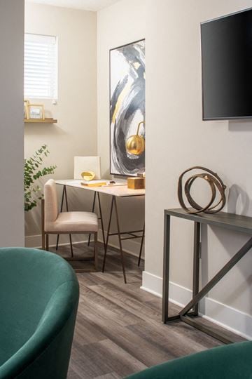 Council Bluffs apartment for rent - a living room with a desk and a chair and a television