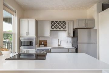 Sioux City apartment for rent - A modern kitchen with a stainless steel refrigerator and white countertops.