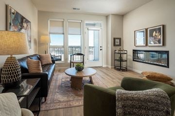 Omaha apartment for rent - A living room with a green couch and a coffee table.