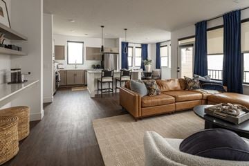 Omaha apartment for rent - A living room with a brown couch and a grey armchair.