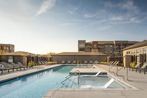 Lincoln apartment for rent - A large outdoor swimming pool with steps leading into the water.