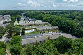 Simpsonville apartment for rent - A large building complex surrounded by trees.