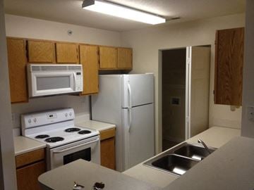 Johns Island apartment for rent - an empty kitchen with a stove refrigerator and sink