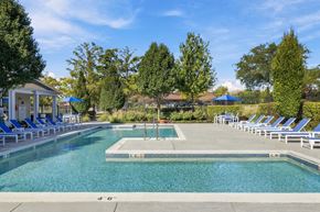 Carol Stream apartment for rent - A large swimming pool surrounded by blue lounge chairs.