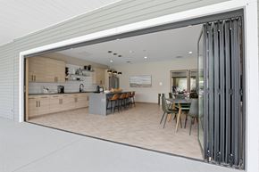 Lake Bluff apartment for rent - A modern kitchen with a dining table and chairs is visible through a glass door.