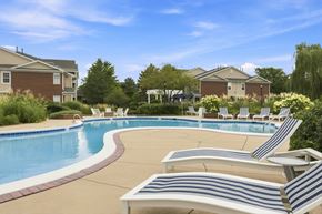 St. Charles apartment for rent - A pool with a white and blue striped sun lounger.