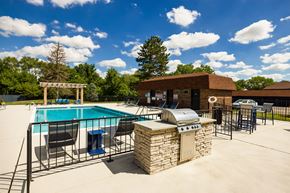 Bensenville apartment for rent - outdoor grilling station near a swimming pool
