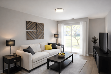 Lake Bluff apartment for rent - A living room with a white couch, a coffee table, and a television.