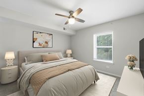 Arlington Heights apartment for rent - A bedroom with a large bed and a ceiling fan.